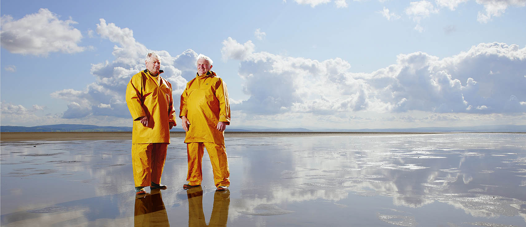Commercial Photography: Portrait of shrimp farmers on Morecambe Bay with incoming tide