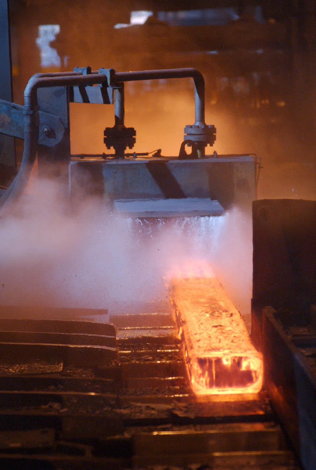 Industrial and Commercial Photographer: Steel Bloom entering roller area in steel fabrication, Workington, UK