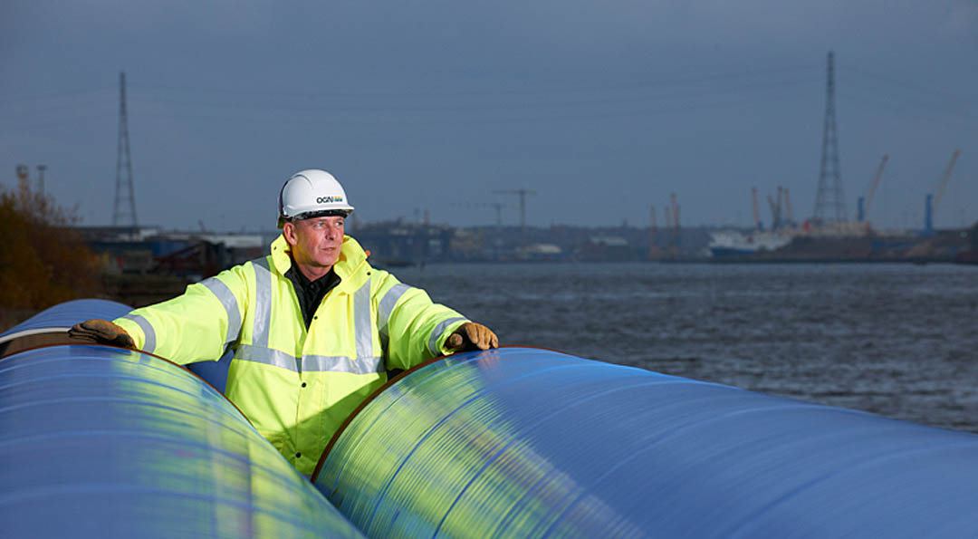 Industrial Photography: Industrial portrait of shipping handler. Water pipeline operative